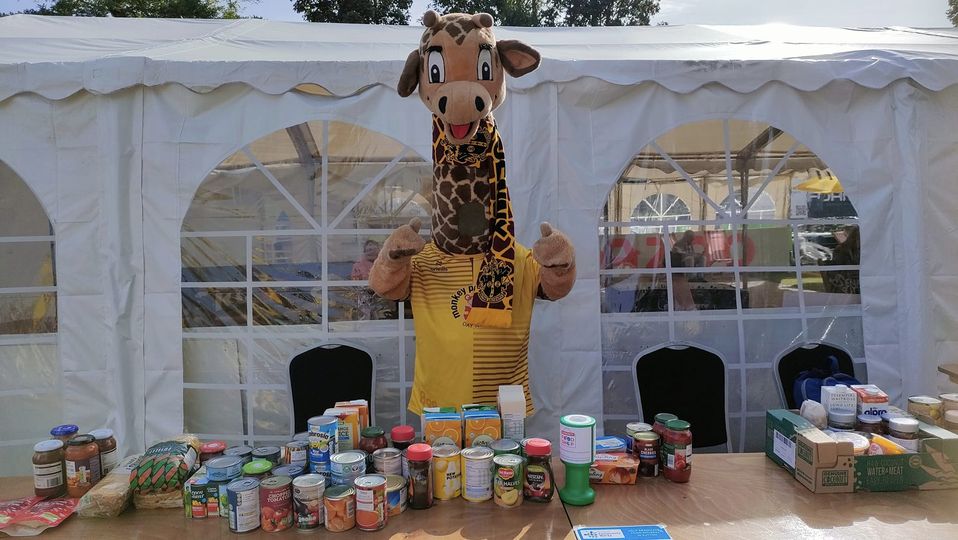 Sutton United mascot with food donations.